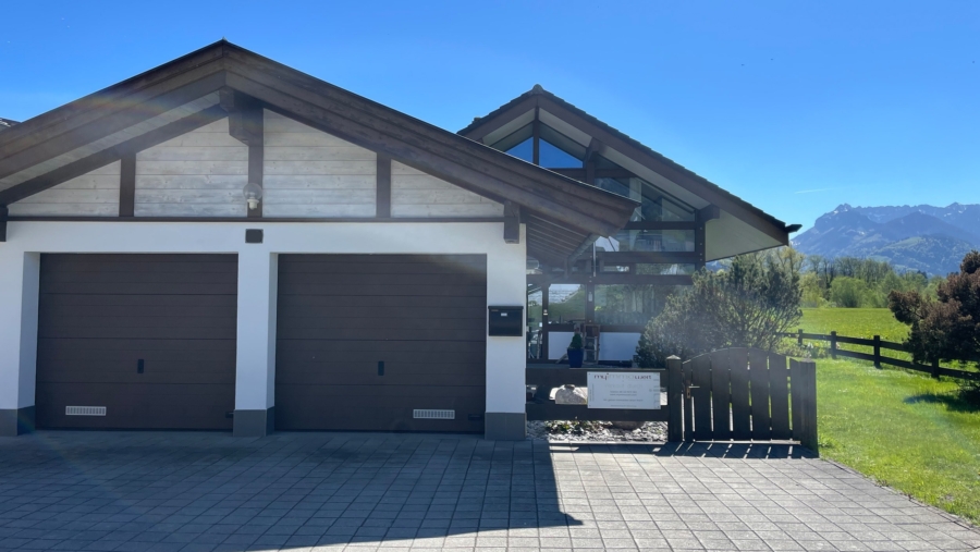 Modernes Einfamilienhaus (HUF-Haus) in Traumlage unweit der Kössener Ache mit herrlichem Bergblick - Hausansicht mit Doppelgarage