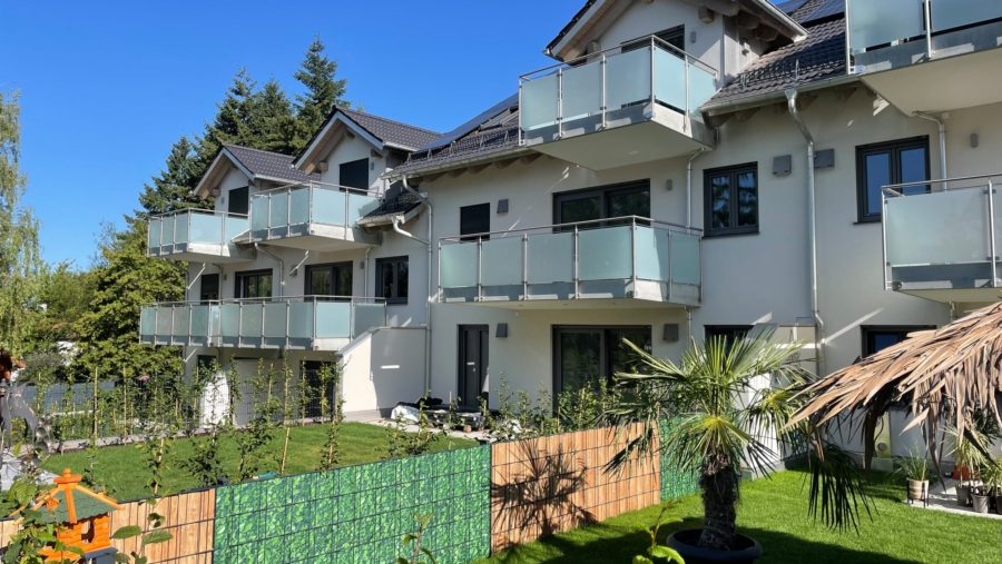 Schöne 3-Zimmer-Gartenwohnung mit 92 m² Wohnfläche, großem Südgarten & 2 TG-Stellplätzen - Hausansicht 2